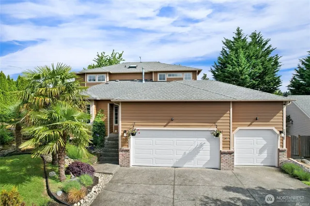 a front view of a house with a yard and garage
