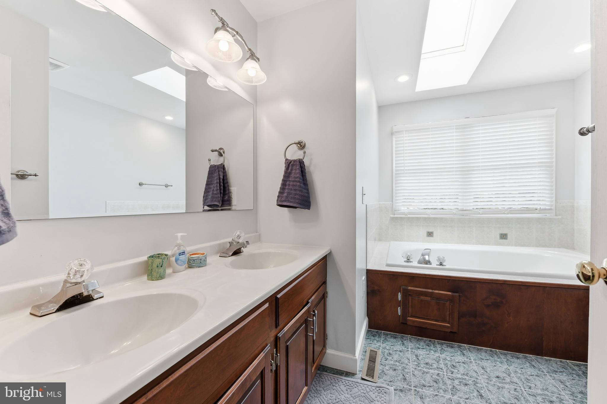 3121 South Wagner Circle Sinking Spring, PA 19608 - Photo 20 of 30 a bathroom with a double vanity sink large mirror and bathtub