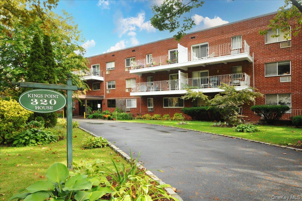 320 East Shore Road, Unit C Great Neck, NY 11023 - Photo 1 of 29 a front view of a house with a yard and potted plants