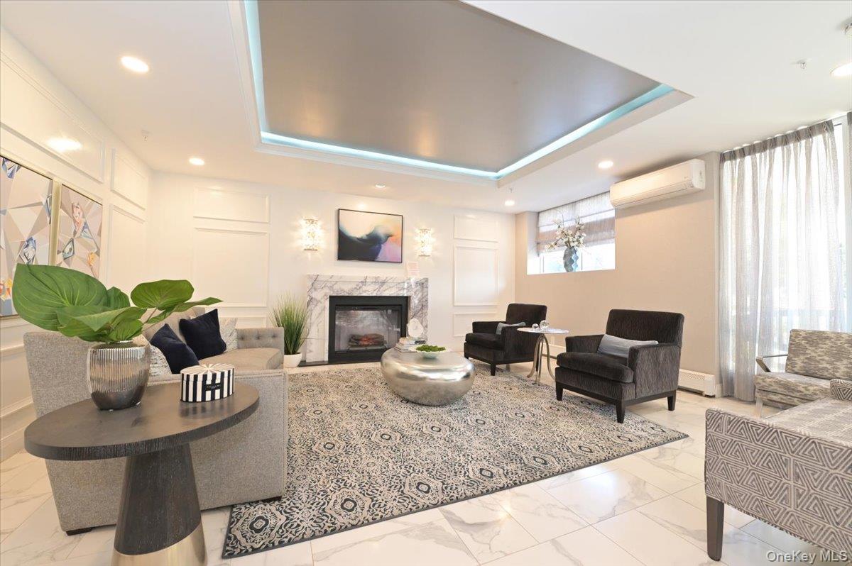 320 East Shore Road, Unit C Great Neck, NY 11023 - Photo 11 of 29 a living room with furniture potted plant and a fireplace