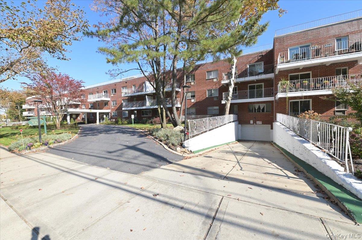 320 East Shore Road, Unit C Great Neck, NY 11023 - Photo 19 of 29 a building view with a outdoor space