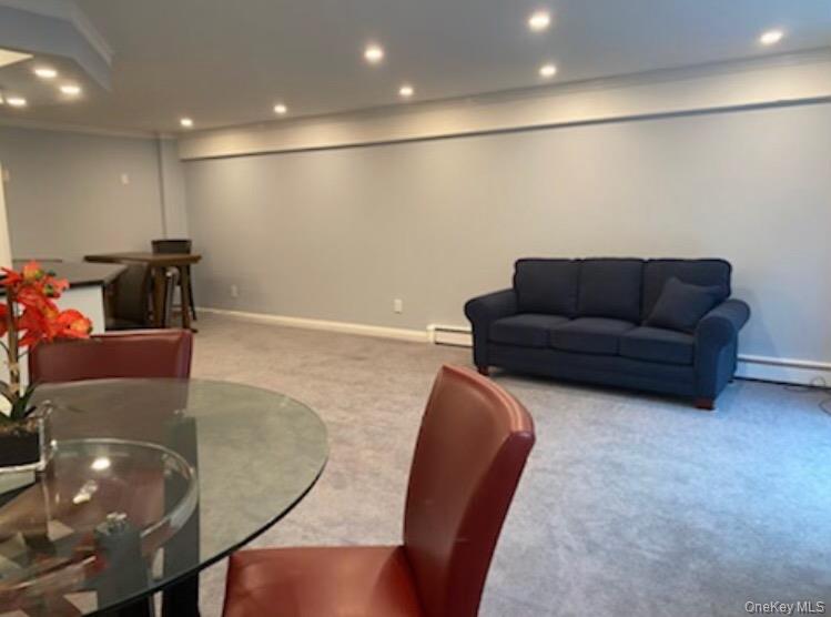 320 East Shore Road, Unit C Great Neck, NY 11023 - Photo 20 of 29 a living room with furniture and a chandelier