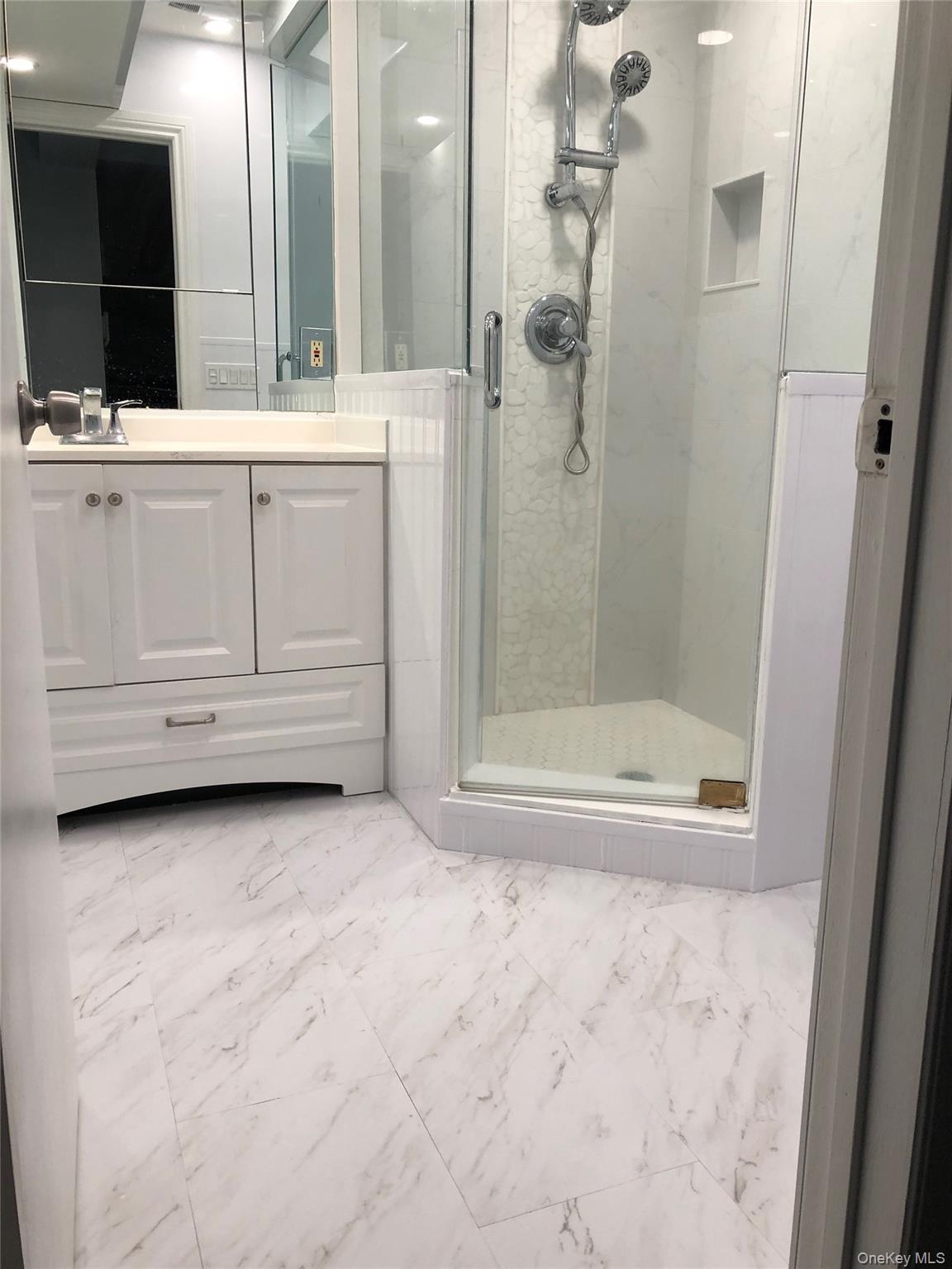 320 East Shore Road, Unit C Great Neck, NY 11023 - Photo 22 of 29 a bathroom with a bathtub and a shower