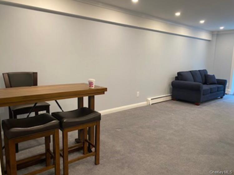 320 East Shore Road, Unit C Great Neck, NY 11023 - Photo 26 of 29 a living room with furniture and a table