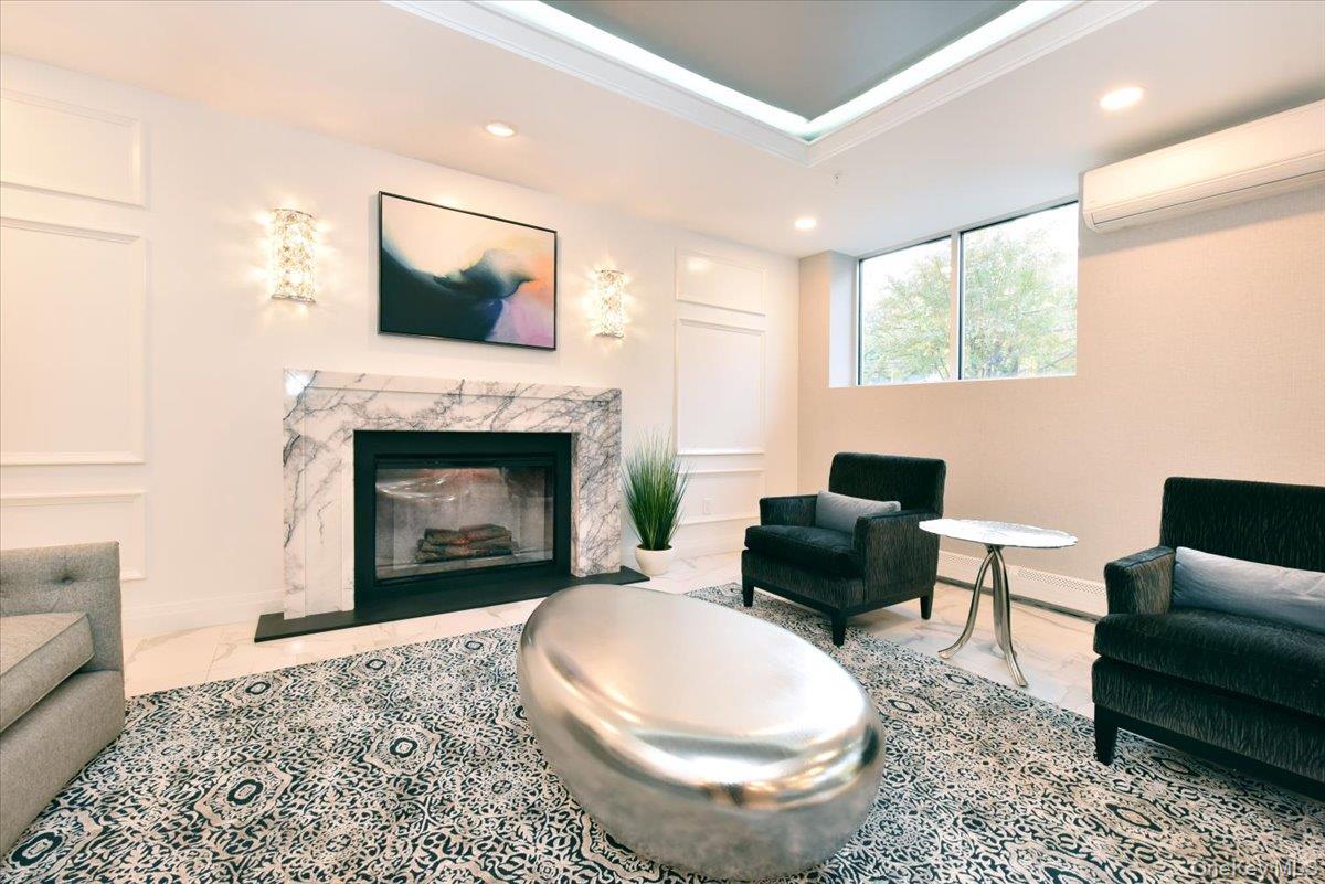 320 East Shore Road, Unit C Great Neck, NY 11023 - Photo 7 of 29 a living room with furniture and a fireplace
