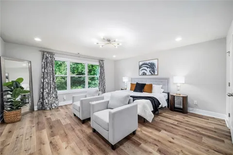 a bedroom with furniture and a large window