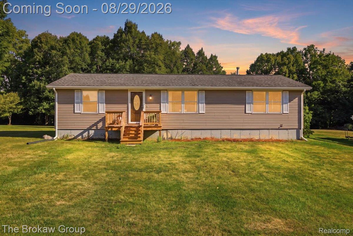5411 Hess Road Dryden, MI 48428 - Photo 1 of 56 Single-story residence featuring horizontal siding, white window shutters, and a wood-finish front porch