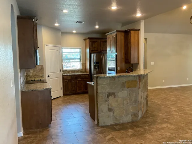 a kitchen with stainless steel appliances granite countertop a stove and a sink