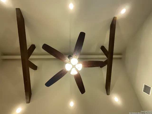 a spacious bathroom with a granite countertop sink and a mirror