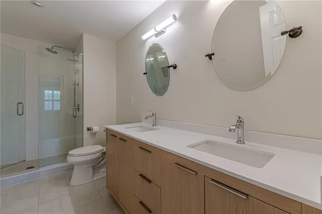 a spacious bathroom with a double vanity sink and a mirror