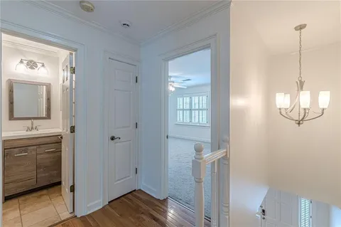 a bathroom with a sink a toilet a mirror and shower