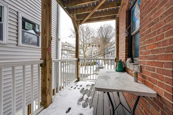 a view of balcony with a table and chairs