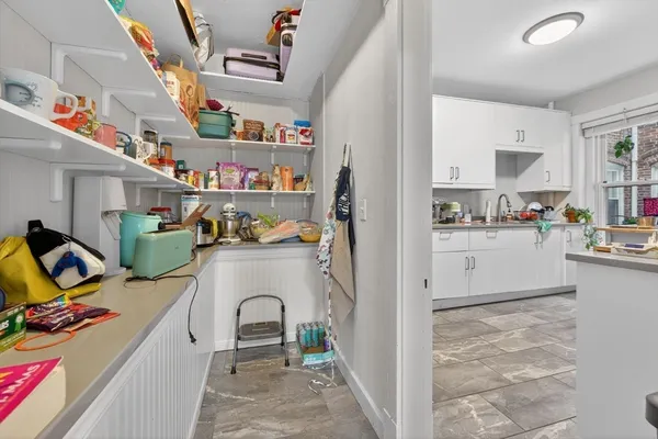 a kitchen with stainless steel appliances granite countertop a sink and a refrigerator