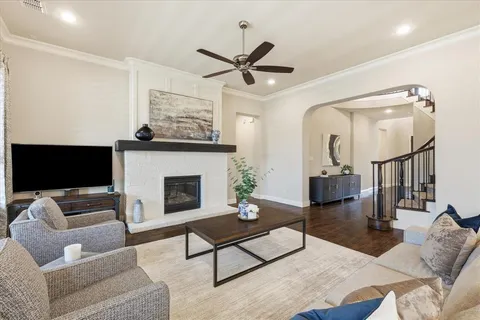 a living room with furniture a rug and a fireplace
