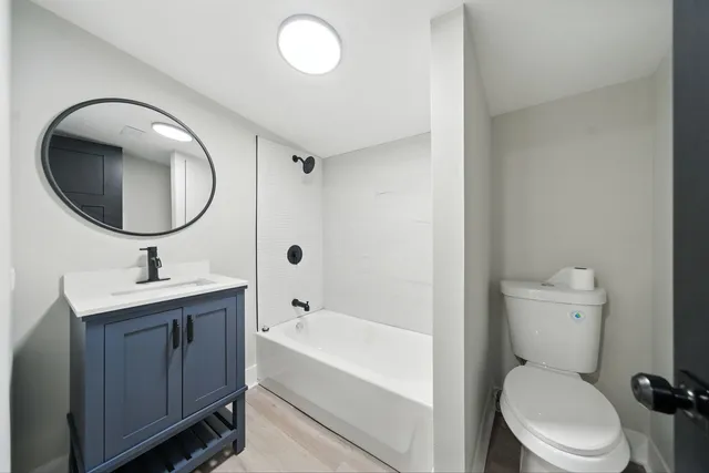 a bathroom with a toilet a sink and a mirror