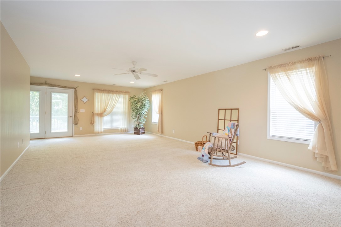 125 Inlet Pointe Drive Anderson, SC 29625 - Photo 21 of 39 A spacious room offers comfortable carpet flooring and abundant natural light from multiple windows and French doors.