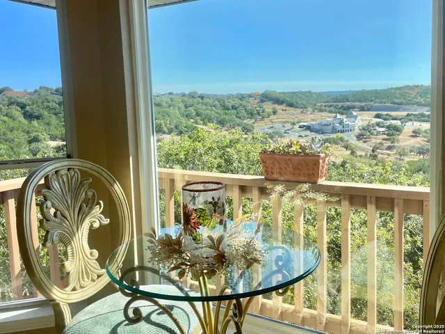 a view of a chairs and table in the balcony