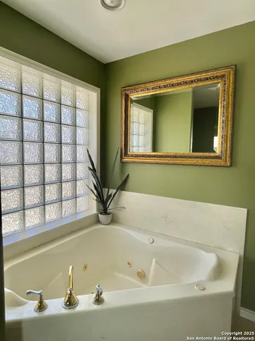 a bath tub sitting in a bathroom next to a window