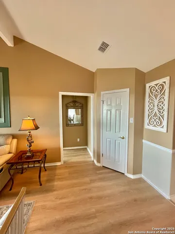 a view of a livingroom with wooden floor and furniture