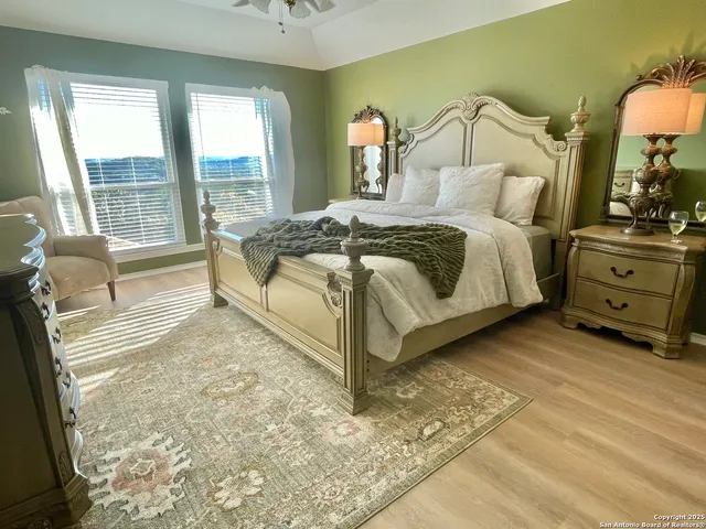 a bedroom with a bed and a dresser next to a window