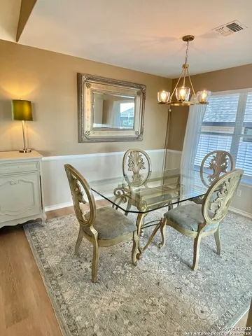 a dining room with furniture and window