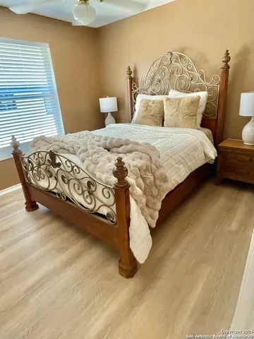 a bed sitting in a bedroom next to a window