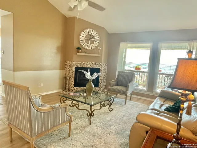 a living room with furniture a fireplace and a flat screen tv