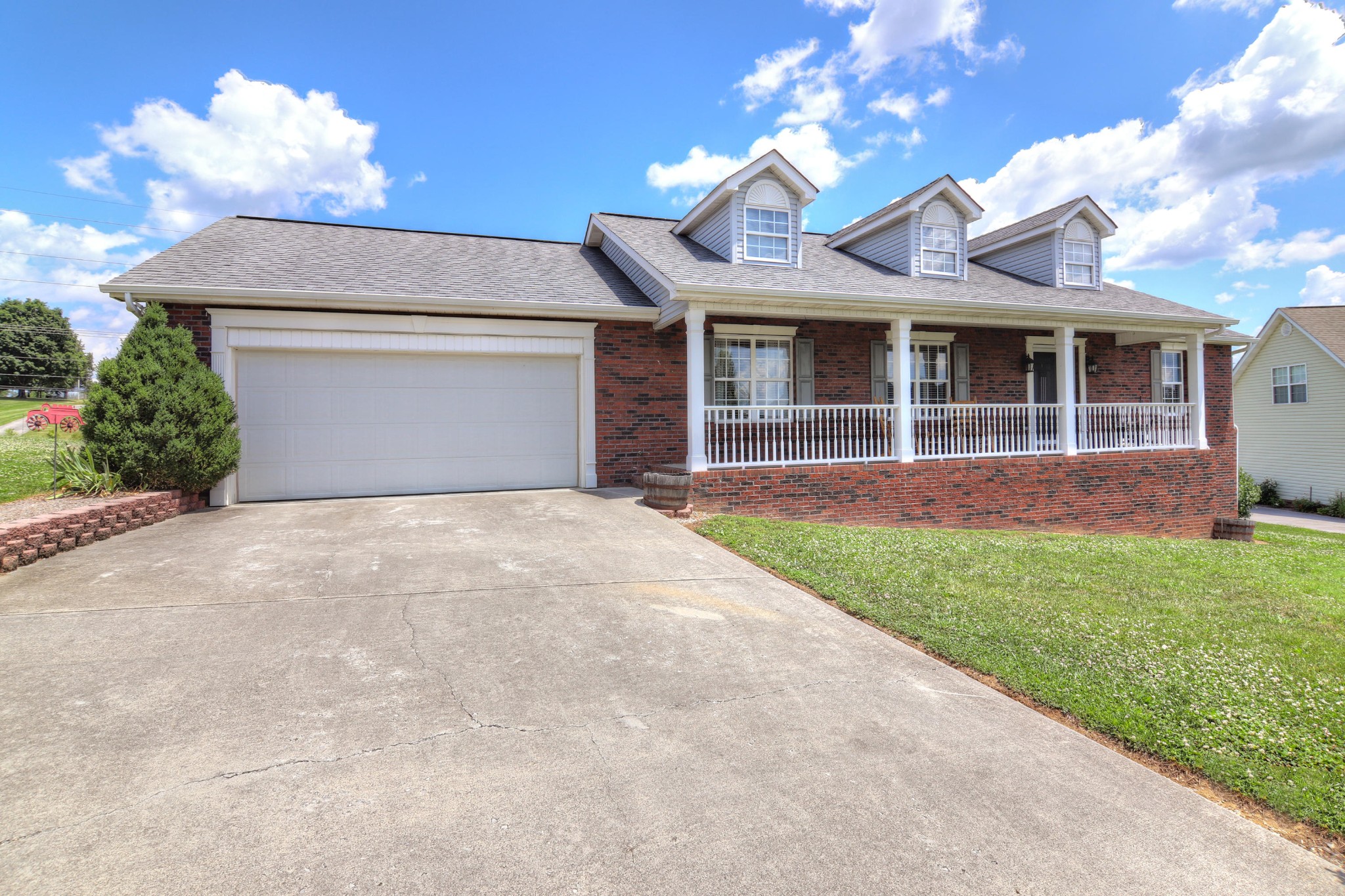 7332 Fort Apache Road Corryton, TN 37721 - Photo 2 of 13 a front view of a house with a garden and yard