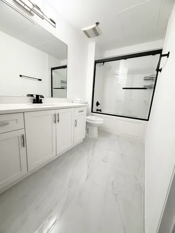 a spacious bathroom with a double vanity sink a mirror and shower