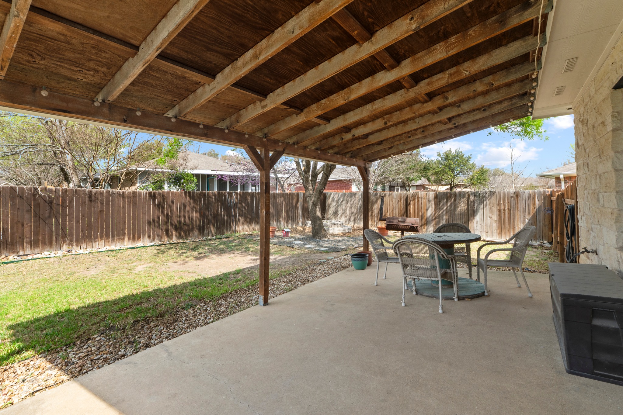 11820 Dunfries Lane Austin, TX 78754 - Photo 11 of 35 a view of a patio with table and chairs with wooden floor next to a yard
