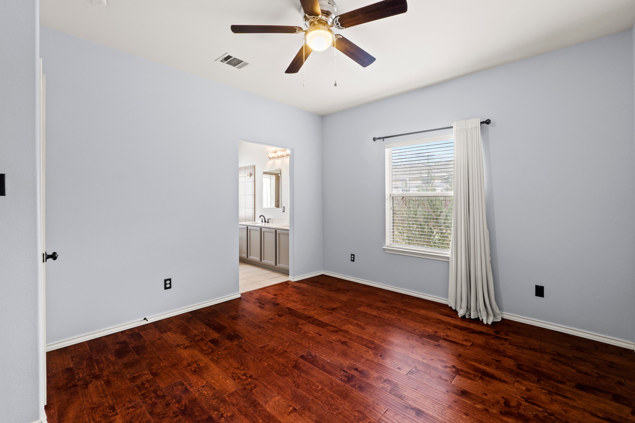 11820 Dunfries Lane Austin, TX 78754 - Photo 13 of 35 a view of empty room with wooden floor and fan