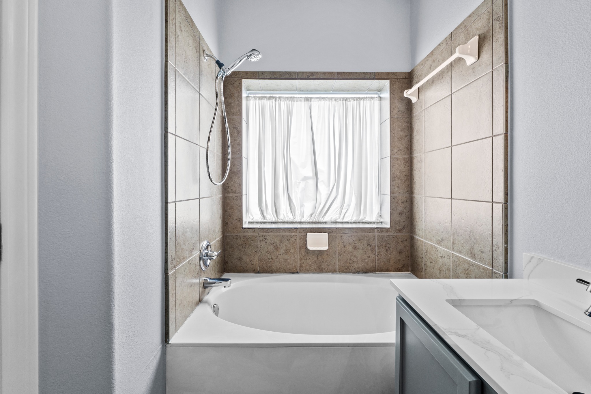 11820 Dunfries Lane Austin, TX 78754 - Photo 16 of 35 a bathroom with a tub sink and window