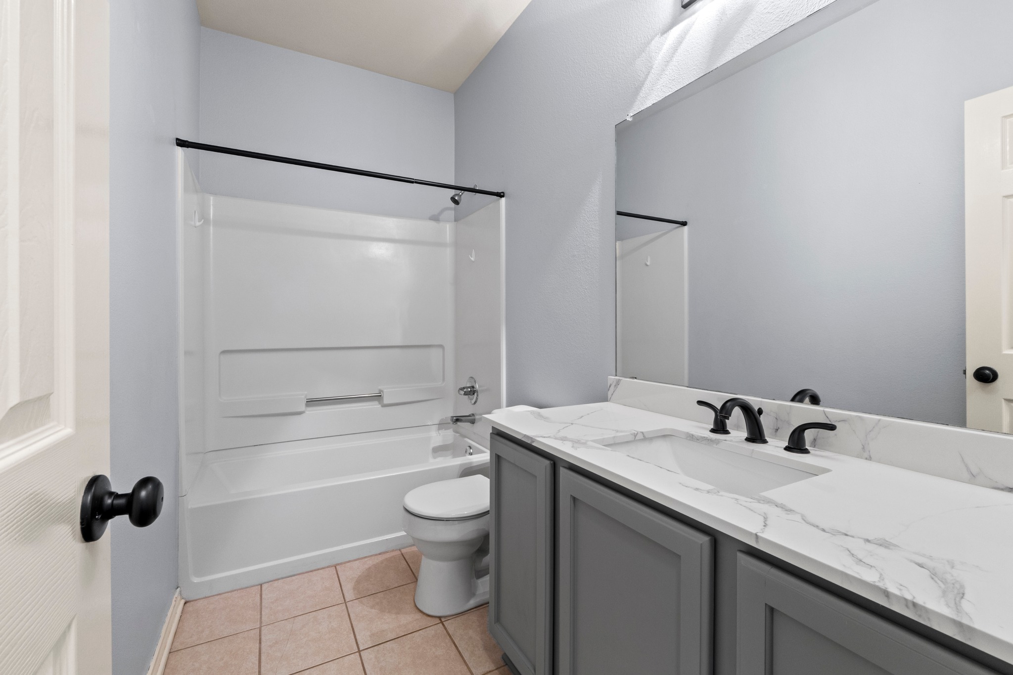 11820 Dunfries Lane Austin, TX 78754 - Photo 19 of 35 a bathroom with a granite countertop sink toilet and shower