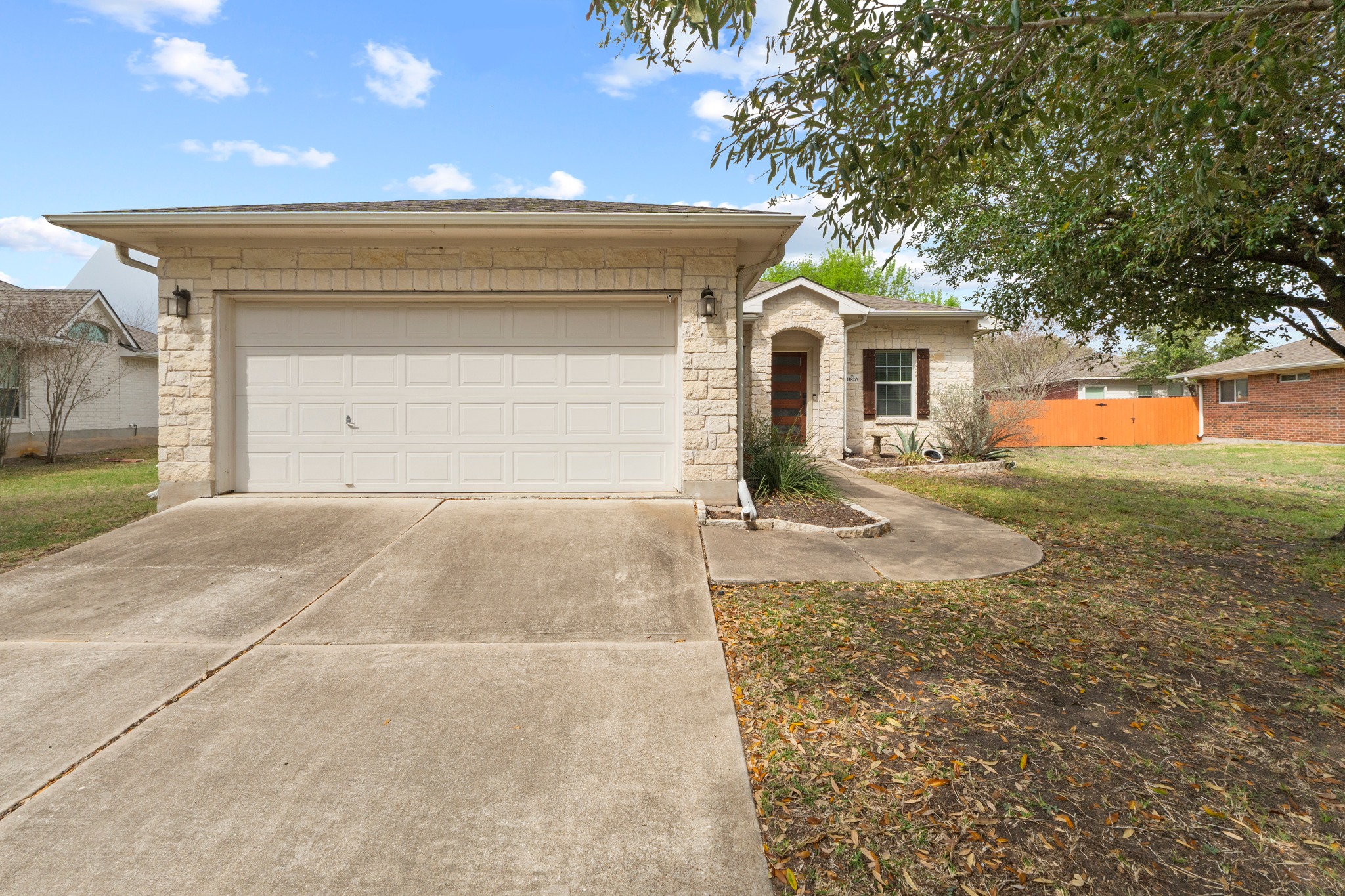 11820 Dunfries Lane Austin, TX 78754 - Photo 2 of 35 a front view of a house with a yard and garage