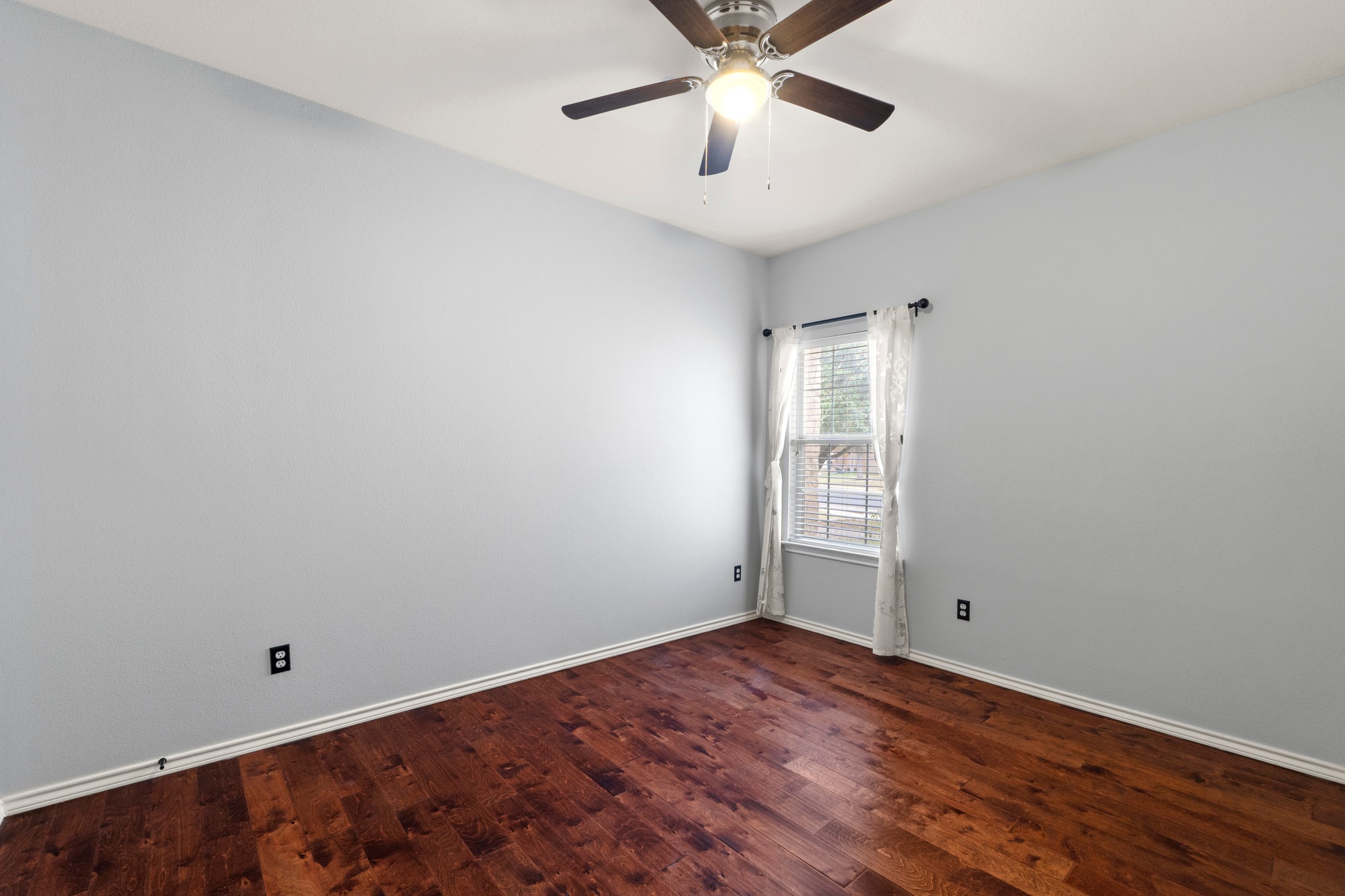 11820 Dunfries Lane Austin, TX 78754 - Photo 21 of 35 an empty room with a window and ceiling fan