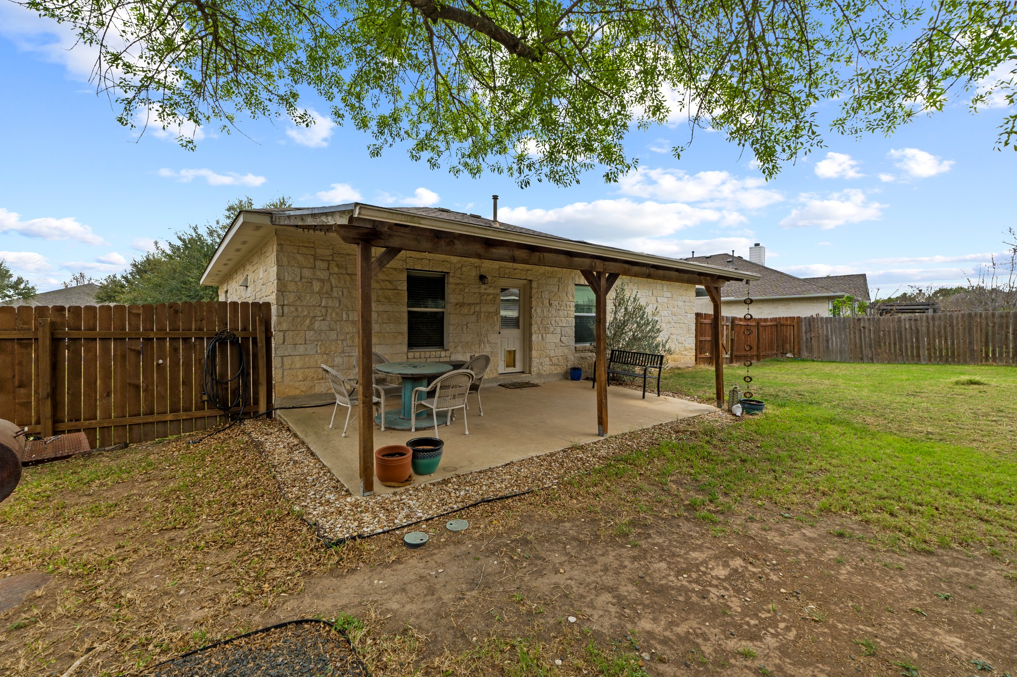 11820 Dunfries Lane Austin, TX 78754 - Photo 24 of 35 a view of a chair and table in the backyard