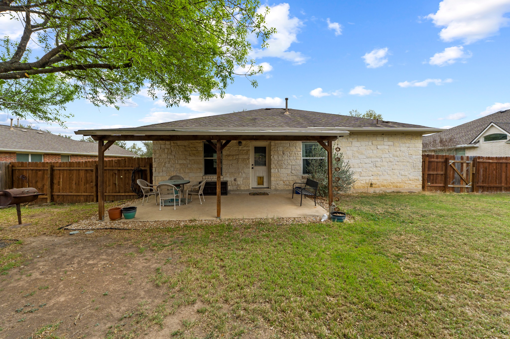 11820 Dunfries Lane Austin, TX 78754 - Photo 25 of 35 a backyard of a house with yard and outdoor seating