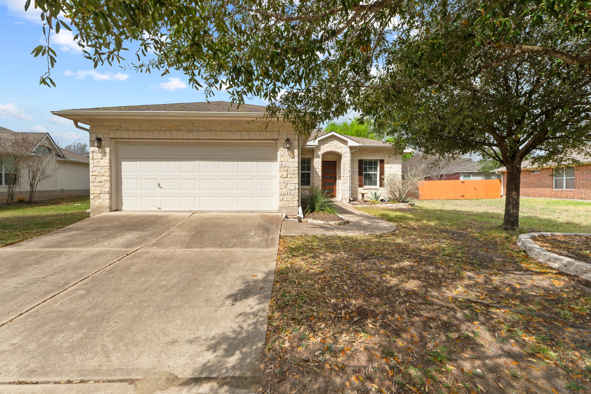11820 Dunfries Lane Austin, TX 78754 - Photo 3 of 35 a front view of a house with a yard and garage