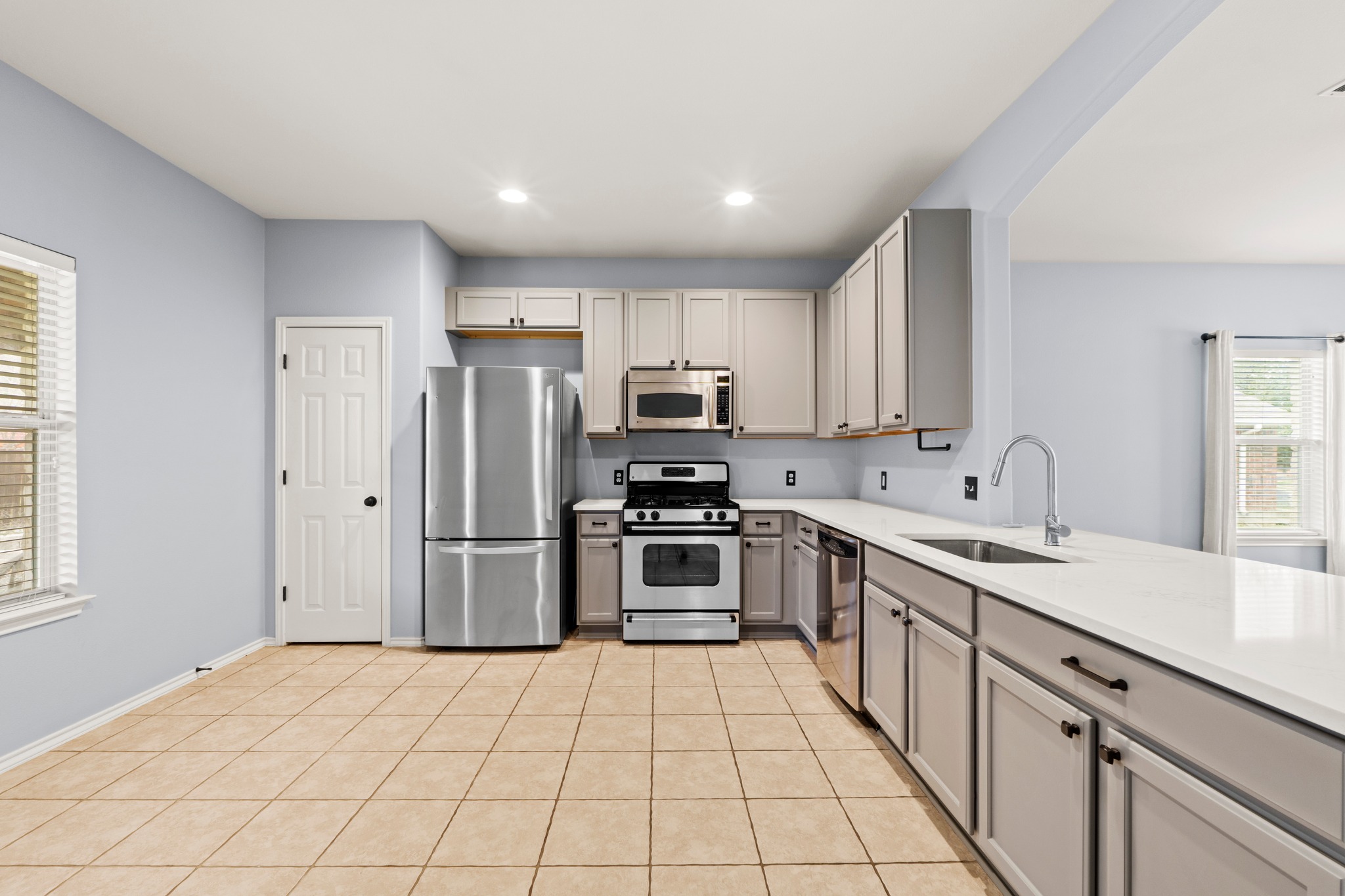 11820 Dunfries Lane Austin, TX 78754 - Photo 6 of 35 a kitchen with stainless steel appliances a refrigerator sink and microwave