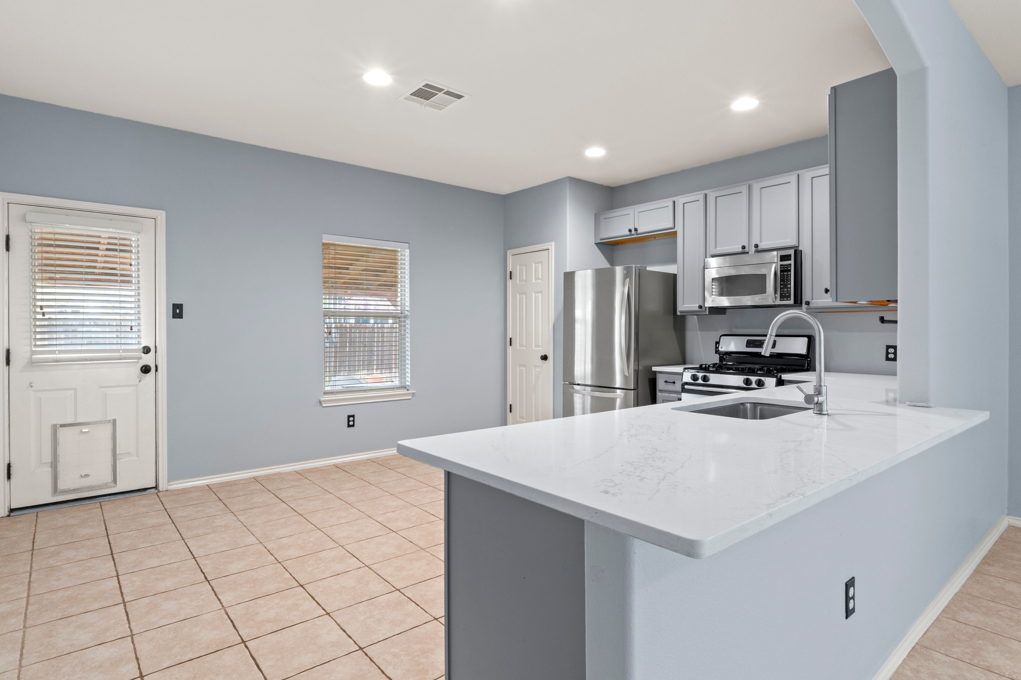 11820 Dunfries Lane Austin, TX 78754 - Photo 7 of 35 a kitchen with stainless steel appliances a refrigerator sink and cabinets
