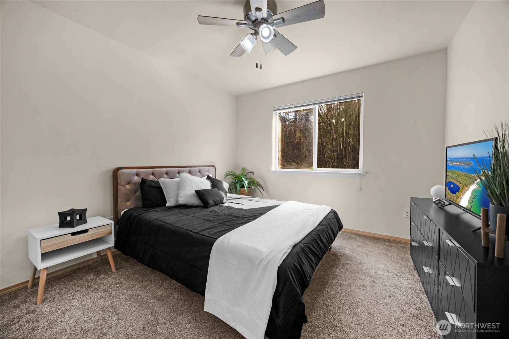 11628 50th Drive Southeast Everett, WA 98208 - Photo 16 of 37 a bedroom with a bed and a flat tv screen on dresser