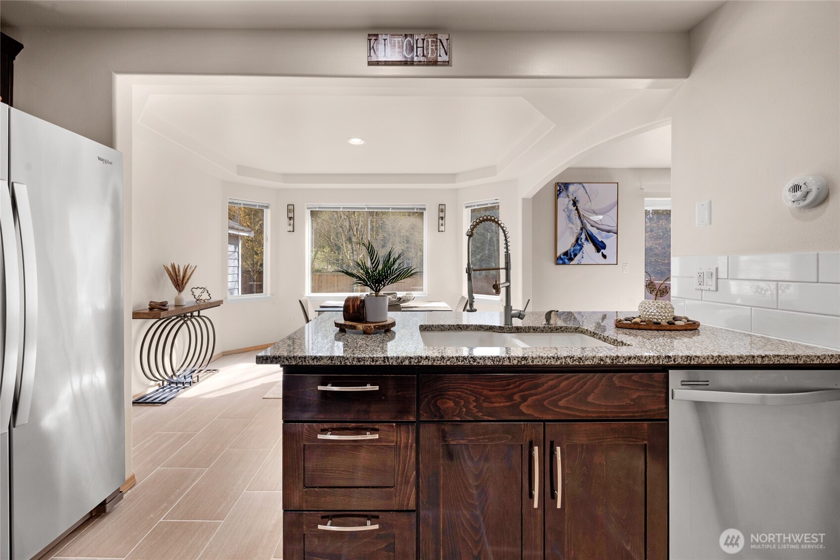 11628 50th Drive Southeast Everett, WA 98208 - Photo 7 of 37 a kitchen with granite countertop a sink and a refrigerator