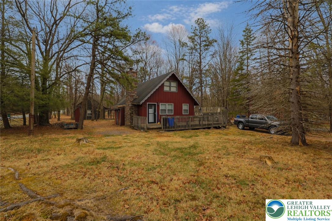 170 Fern Ridge Road Blakeslee, PA 18610 - Photo 2 of 17 a house with trees in front of it