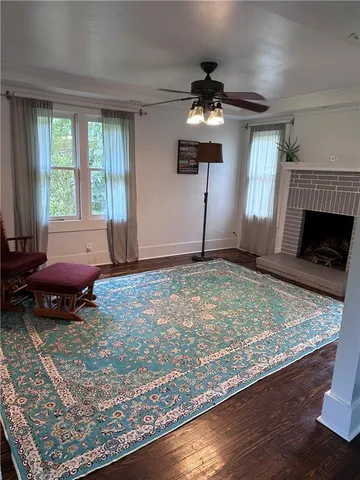 a living room with hard wood floors and a fireplace