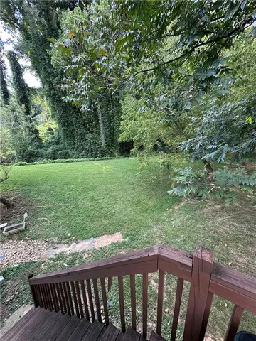 a view of a wooden fence and trees in the background