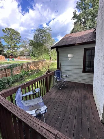 a view of a wooden deck with a yard
