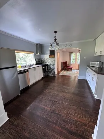 a large kitchen with a stove and a refrigerator