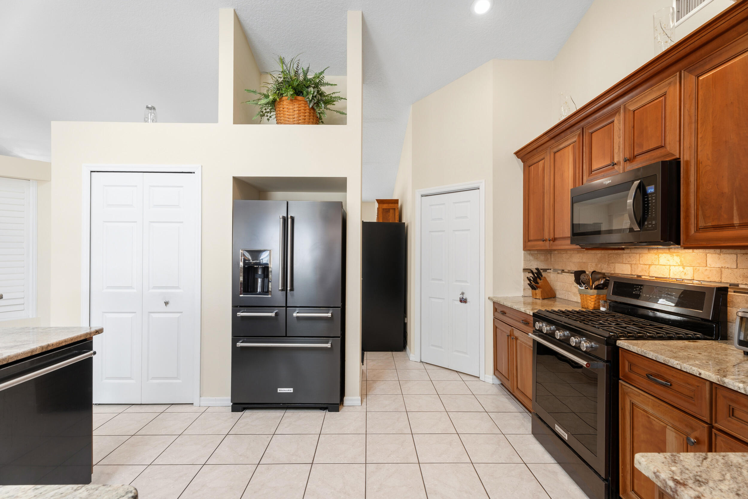 5593 Northwest Wesley Road Port St. Lucie, FL 34986 - Photo 13 of 33 Black stainless appliances and pantry