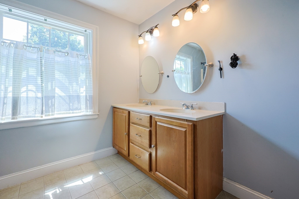 8 A Whitins Road Sutton, MA 01590 - Photo 16 of 26 a bathroom with a sink vanity and a mirror