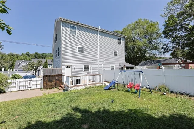a view of a backyard with a slide and a table and chairs